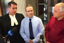 Glen Assoun, centre, is shown with his lawyer Sean MacDonald, left, and Ron Dalton, co-founder of Innocence Canada.