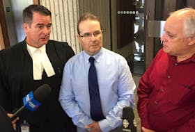 Glen Assoun, centre, is shown with his lawyer Sean MacDonald, left, and Ron Dalton, co-founder of Innocence Canada.