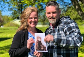 
Long lost cousins, Richard Anderson (right) and Joelene Arenburg, with a photo of Anderson’s great-great-great grandmother. 
