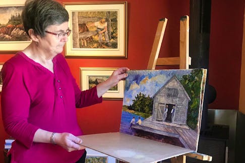 
Acadian artist June Deveau looks through some works in progress in her studio behind her home in Saint-Alphonse. PAT LEE 

