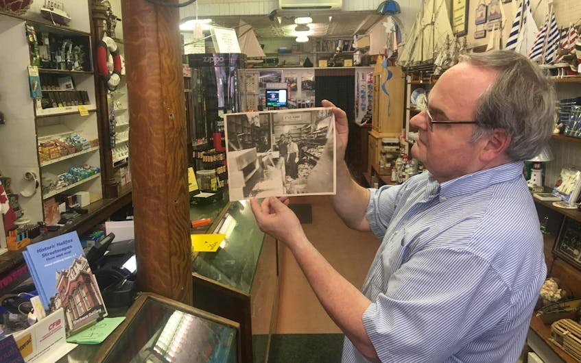 
Standing in exactly the same spot, Craig Sievert shows the interior of his family tobacco store after the VE-Day rioting on Barrington Street in 1945. - John DeMont
