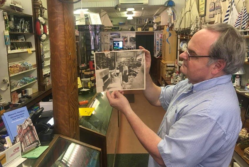 
Standing in exactly the same spot, Craig Sievert shows the interior of his family tobacco store after the VE-Day rioting on Barrington Street in 1945. - John DeMont
