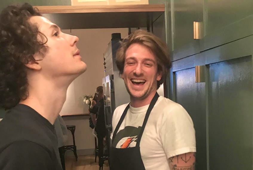 Keegan deWitt of Halifax, right, and a colleague share a laugh just inside the kitchen at Dreyfus, the critically acclaimed Toronto restaurant where deWitt has found the perfect food industry job.