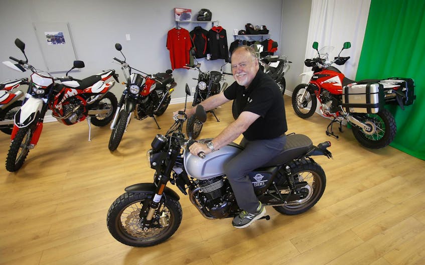 
Bill Scott sits on one of the SWM motorcycles he sells at Moto Italia in Dartmouth. - Tim Krochak

