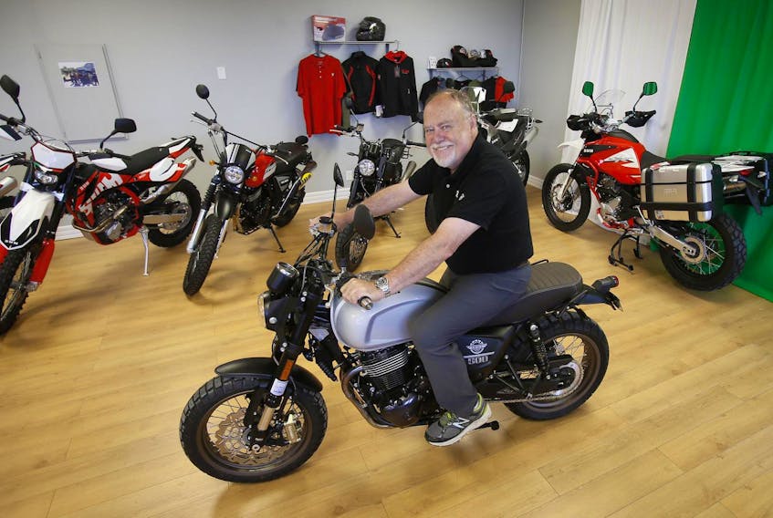 
Bill Scott sits on one of the SWM motorcycles he sells at Moto Italia in Dartmouth. - Tim Krochak

