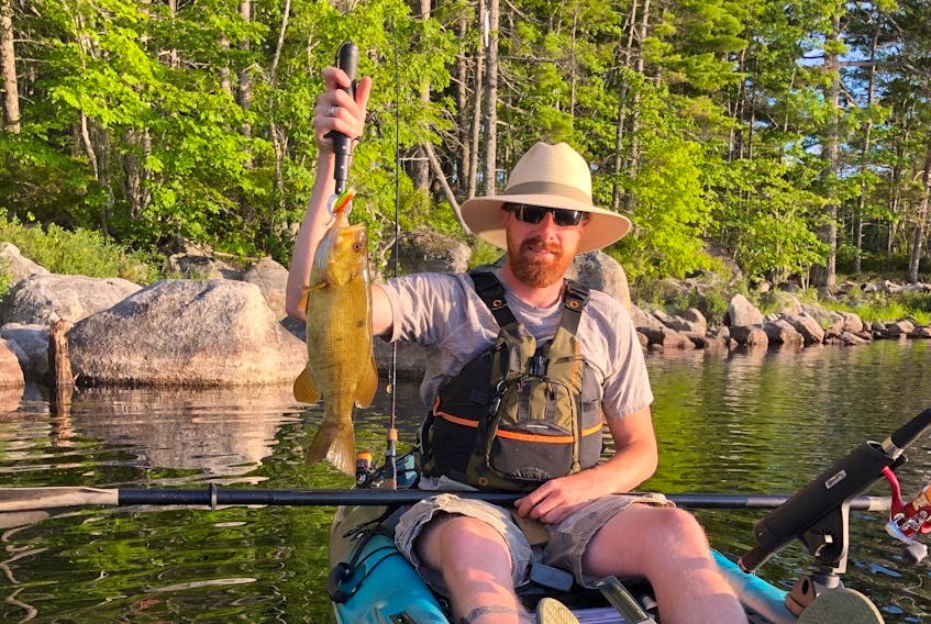 
Luke Osborne holds up a small-mouth bass he caught in an Annapolis Valley lake on Sunday evening. The unusual golden-yellow colour appears to be a sign of xanthism, a pigmentation condition related to albinism. Contributed

