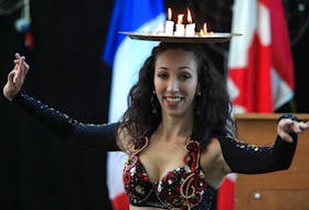 
Laura Selenzi of Serpentine Studios presents a candle tray dance, during a funding announcement to organizations that present festivals, arts performances and community celebrations, at Alderney Landing in Dartmouth on Friday. - Tim Krochak
