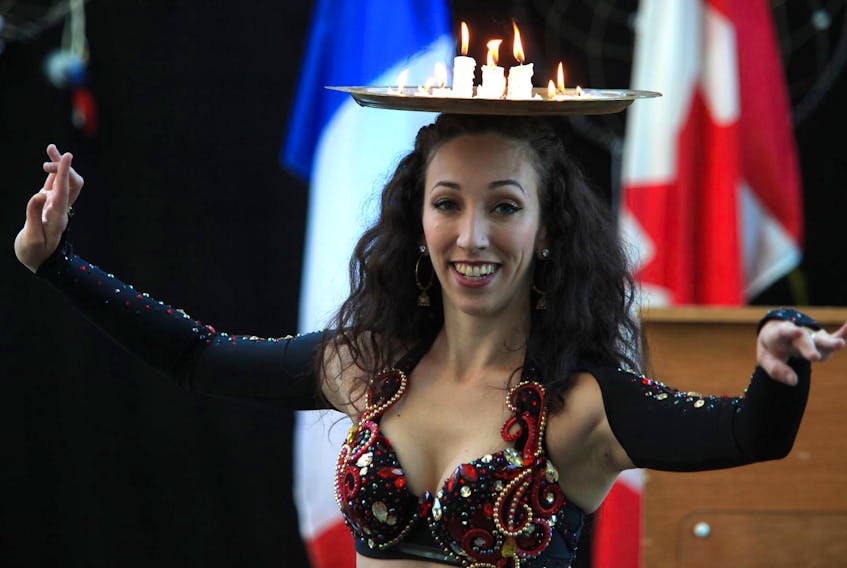 
Laura Selenzi of Serpentine Studios presents a candle tray dance, during a funding announcement to organizations that present festivals, arts performances and community celebrations, at Alderney Landing in Dartmouth on Friday. - Tim Krochak
