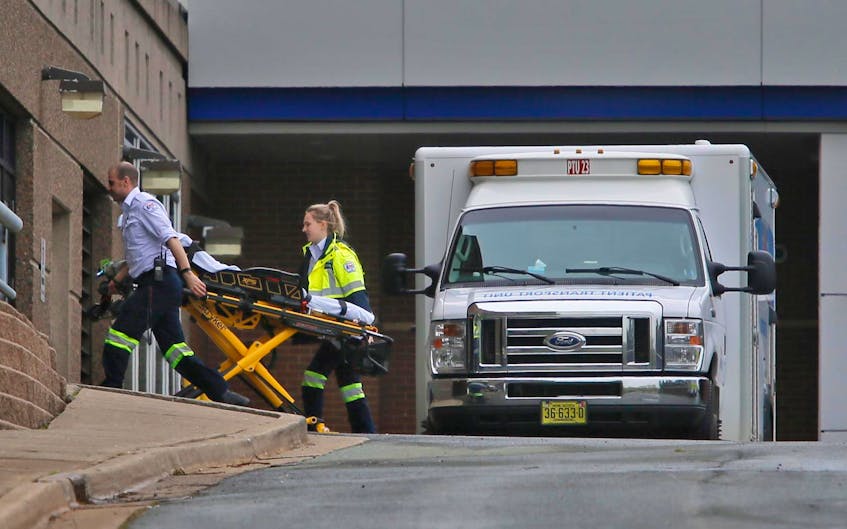 An EHS ambulance crew arrives with an empty stretcher at the Halifax Infirmary in June.