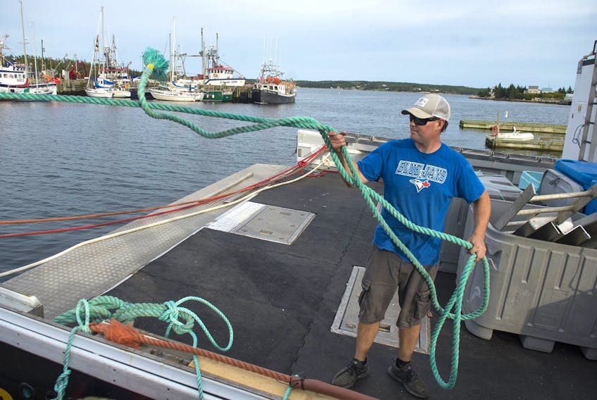 
Harold Henneberry ties down his boat Grand Dad’s Caress in Sambro late Friday afternoon. The HRM has asked people living in the Sambro area, Peggy’s Cove and along the Eastern Shore to make plans to self-evacuate due to Hurricane Dorian’s arrival. - Ryan Taplin
