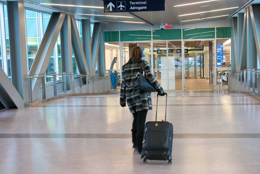 A passenger makes her way into the terminal at Halifax's Stanfield airport.