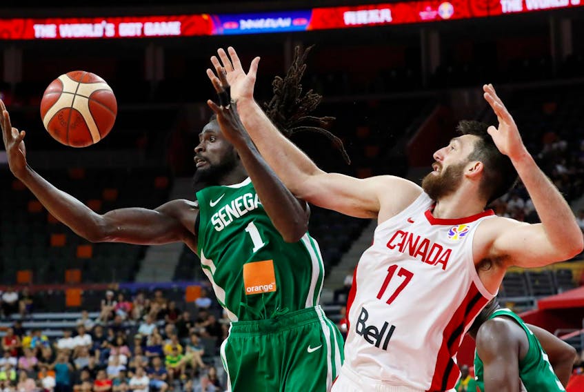 Canada’s Owen Klassen, right, battles for a rebound with Senegal’s Maurice Ndour during action at the FIBA World Cup on Thursday in Dongguan, China.
