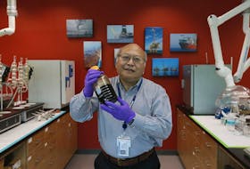 
Ken Lee, a Halifax scientist who is an international expert on cleaning up major oil spills around the world, holds a sample of diluted bitumen, taken from the tar sands in Alberta in a lab at the Bedford Institute of Oceanography in Dartmouth. - Tim Krochak
