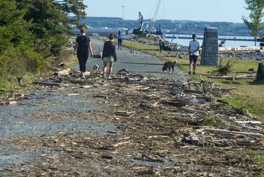 
Visitors to Point Pleasant Park on Tuesday walk through some of the debris left behind from hurricane Dorian’s storm surge. The park fared much better during Dorian than it did during hurricane Juan. - Ryan Taplin
