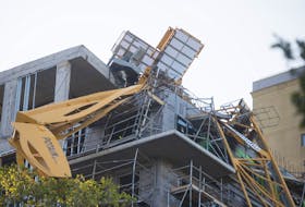 
A crane collapsed onto a building on Brenton Place and Brenton Street on Saturday during hurricane Dorian. - Ryan Taplin 
