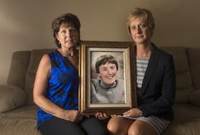 
Sisters Elizabeth Deveau and Dorothy Dunnington hold a photo of their sister Chrissy who died last year from an infected bedsore. - Ryan Taplin
