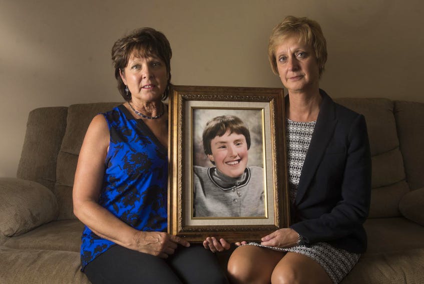 
Sisters Elizabeth Deveau and Dorothy Dunnington hold a photo of their sister Chrissy who died last year from an infected bedsore. - Ryan Taplin
