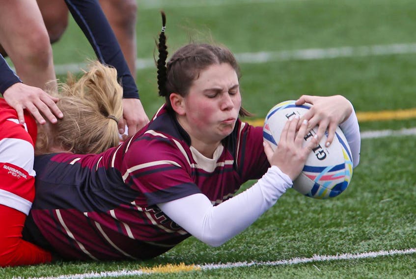 
Citadel Phoenix’s Kathleen Dolan is tackled as she makes a try against Halifax West during metro high school rugby action on the Mainland Common in Halifax on May 16, 2019. - Tim Krochak
