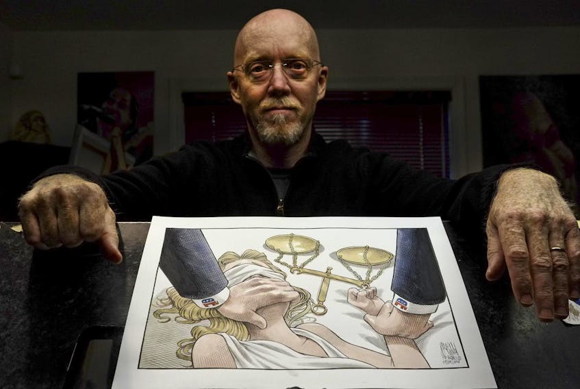 Halifax Chronicle Herald editorial cartoonist, Bruce MacKinnon, is seen with his cartoon, Lady Justice, in his workspace in Halifax. -Tim Krochak