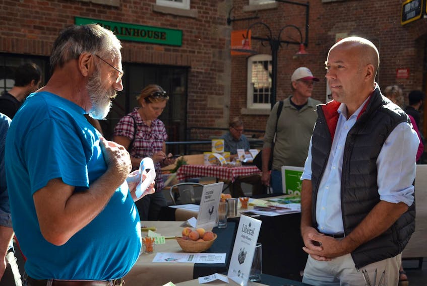 Blake Harris, left, chats with Liberal candidate Andy Fillmore at the Eat Think Vote event at the Halifax Brewery Market in Halifax on Saturday morning. Halifax Citadel-Sable Island federal election candidates Fillmore and Jo-ann Roberts of the Green Party spoke with people at the market about food security and agriculture. NICOLE MUNRO