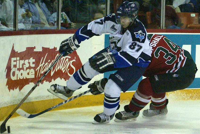 Rimouski Oceanic centre Sidney Crosby gets around Halifax Mooseheads defenceman Randy Upshall during a 2004 QMJHL game in Halifax. (DARREN PITTMAN/File)