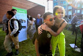 
Youngsters leave after posing for a photo with dignitaries after the announcement of a loan to build a new kitchen for the Hope Blooms community garden in north-end Halifax. 
