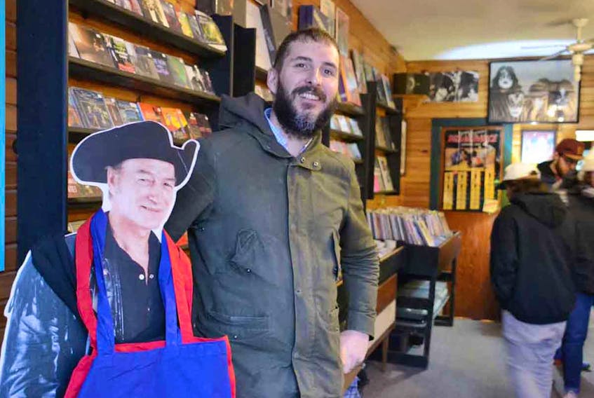 Pat Deighan, owner of Back Alley Music in Charlottetown, poses with the infamous Stompin’ Tom cut-out that stands in the store’s entrance. Back Alley Music will be moving to its new location of 257 Queen St. on Jan. 10. KATIE SMITH/THE GUARDIAN