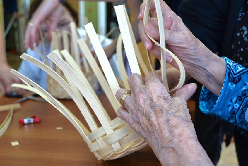 Willing hands weave strips of reed to create a work of art during a basket-weaving course at Stewart Memorial Home in Tyne Valley. ERIC MCCARTHY/JOURNAL PIONEER