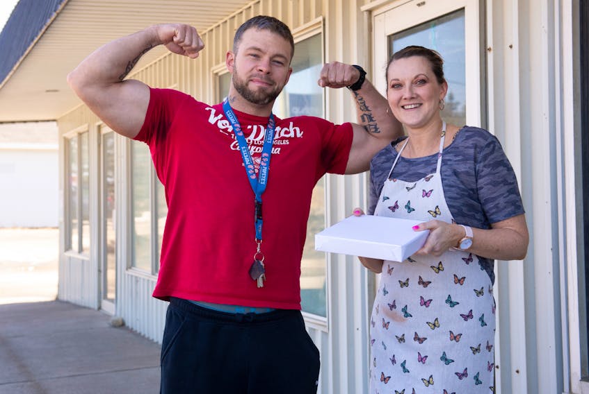 Business owners Sam Burt and Lisa Mehaney have formed an unlikely business alliance with Burt’s gym next door to Mehaney’s pizza restaurant.