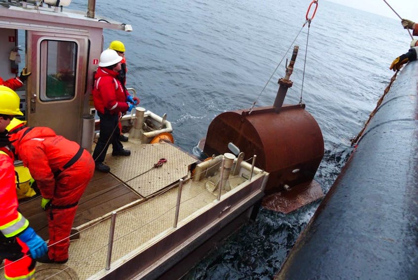 Photo courtesy of the Canadian Coast Guard 
A Canadian Coast Guard environmental response crew preparing to install a cofferdam on the hull of the Manolis L. Oil collected in the old cofferdam was removed and the cofferdam was replaced.