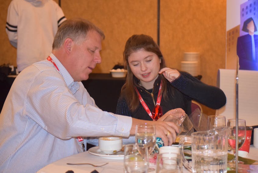 Teacher Chris Ross enjoyed a friendly but businesslike lunch with his student Jessica Graham, during the formal Business and Youth Symposium in Truro on Nov. 22. Both are from South Colchester Academy.