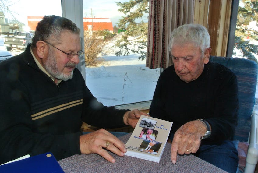 Retired Amherst lawyer Morris Haugg, left, looks over a copy of ‘Me and My Team: From Farmer to Premier’ with former Cumberland East MLA and premier Roger Bacon. Haugg wrote the book about the former premier and longtime Progressive Conservative cabinet minister.