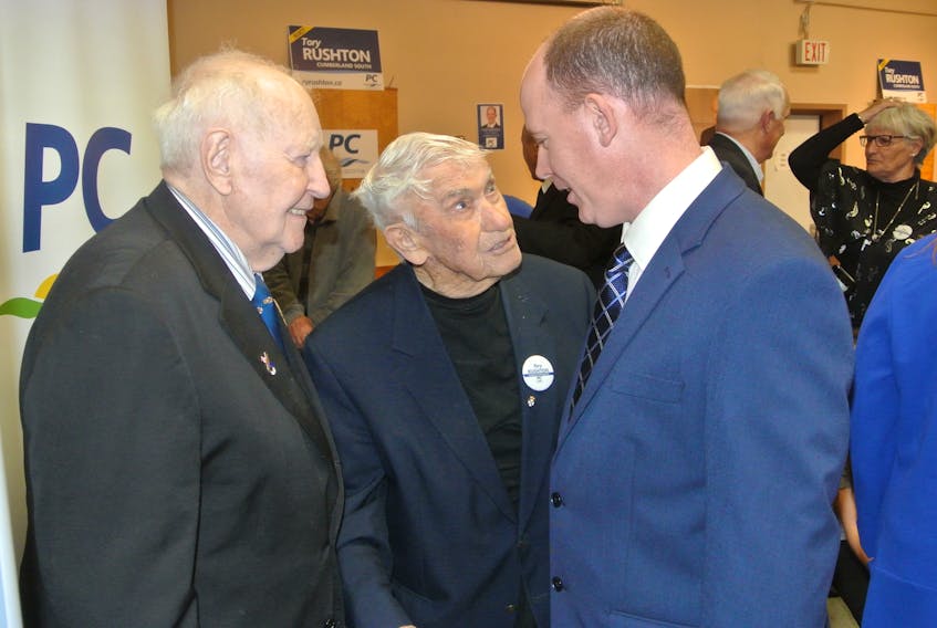 Formier premiers John Buchanan (left) and Roger Bacon (centre) talk with Cumberland South MLA Tory Rushton during his April 2018 nominating meeting in Oxford. Burchanan, the fourth-longest serving premier in Nova Scotia history, passed away on Thursday at age 88. File