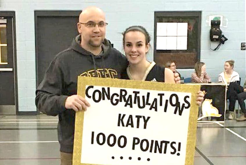 Katy Baker and her coach Dean Smith celebrate after she score her 1000th point at OREC.