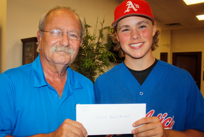Amherst Mayor David Kogon (left) presents a community support grant to Jayden Matheson of the Amherst Athletics, who are hosting the 2018 Baseball Atlantic Bantam AA Baseball Championships at the Robb Complex beginning Friday. - Town of Amherst photo
