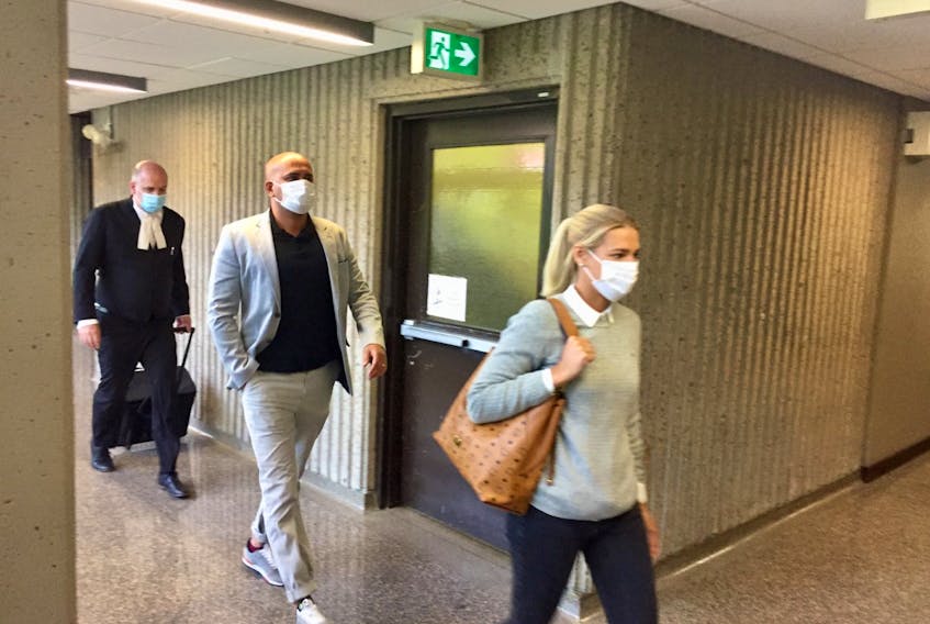 Former Halifax taxi driver Bassam Al-Rawi, who is on trial on a charge of sexually assaulting a woman in December 2012, enters Nova Scotia Supreme Court on Wednesday with his wife and his lawyer.
