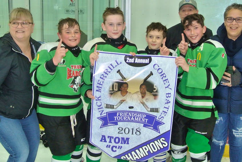 The Truro Green Bearcats defeated the Cumberland Rams to win the atom division at the Corey Bates – Nick Merrill Friendship Minor Hockey Tournament at the Amherst Stadium on March 11. Kathy Lake and Ian and Brenda Merrill present the championship banner to Truro captains (from left) Caleb Marshall, Austyn Burris, Grayson Bond and Cooper Croft.