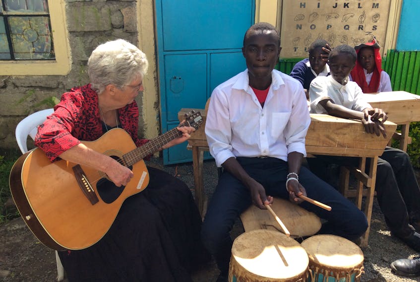Betty Jane Cameron of Mabou is seen at St. Charles Lwanga Secondary School in Nairobi, Kenya, last year, teaching a student guitar.