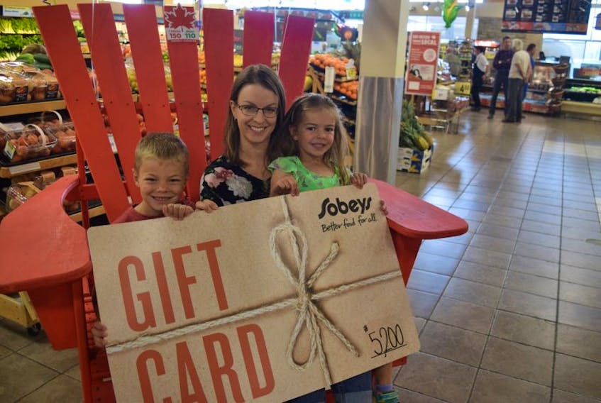 Angie Vankessel and her children Nicholas and Caroline were the lucky winners of $5,200 worth of free groceries from a contest they entered at Sobeys.