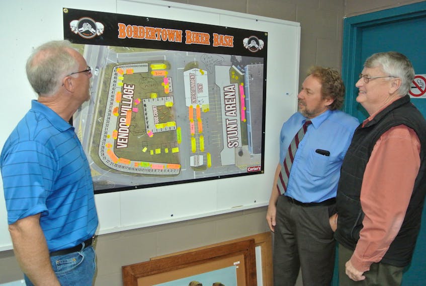 Bordertown Biker Bash organizing committee members Peter Rushton (left), Randy Thurber (centre) and John Warner look over the layout for the fourth annual festival that will run from July 13 to 15 at the Amherst Superstore parking lot.