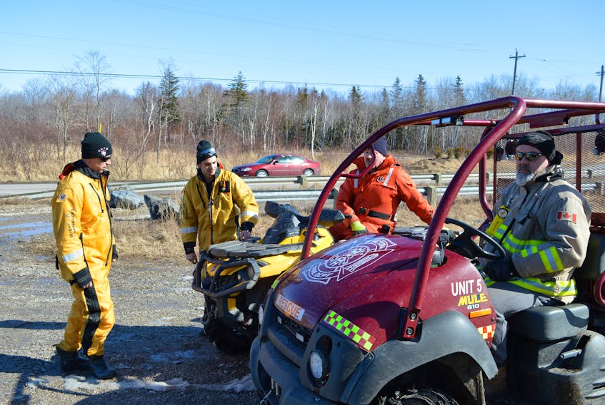 Members of the New Victoria Volunteer Fire Department (from the left) Steven Berger, Tyler Cassidy, Steve Jessome and Rickey Jury, at the Summit on Daley Road in New Victoria Monday morning during the search for a New Victoria woman who was reported missing Saturday night while cross-country-skiing in the area. The body of Debbie Lee Pearson was found in Waterford Lake at about 10:40 a.m. Monday.