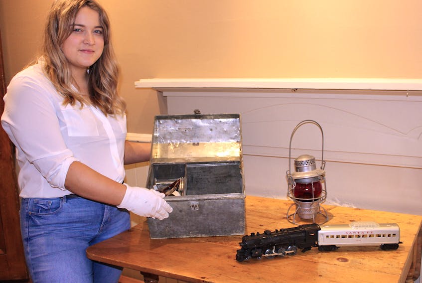 Michelle Roy, a student intern who worked for the Tantramar Heritage Trust this summer and helped put together the history on Sackville’s railway and its impact on the community, displays some of the items that will be included in the exhibit.