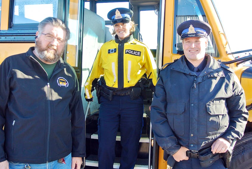 Delbert Green, transportation supervisor for the CCRSB, is joined with Amherst police officers Const. Michelle Harrison and Const. Tom Wood in calling on increased awareness by motorists in school zones. Missing is Const. Angela Downey of the Cumberland RCMP.