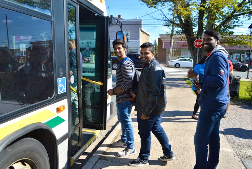 Friends and Cape Breton University students, from the left, Sarin Spillai, Ajay Kuruvilla Matthew and Aswin Pariyaran, get on a CBRM transit bus in Glace Bay heading to CBU. The students said there is a lack of buses and if one breaks down they are stuck with no transportation.