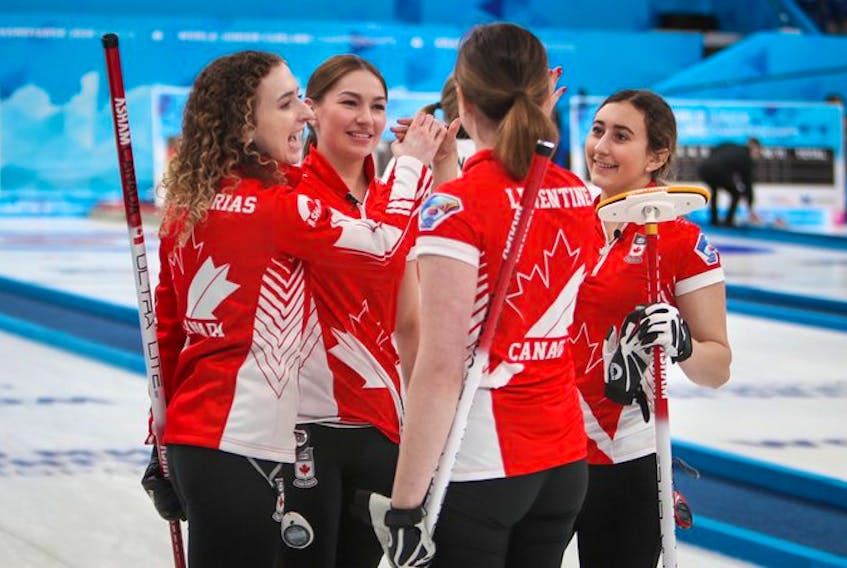 Karlee Burgess, second from left celebrates with teammates Mackenzie Zacharias, left, Lauren Lenentine and Emily Zacharias after winning the world junior curling championships in Krasnoyarsk, Russia, on Saturday. Contributed