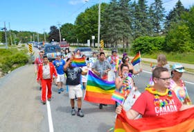 Participants paraded through the First Nation's community for the Kepmitelsi Eskasoni Pride walk on Saturday.