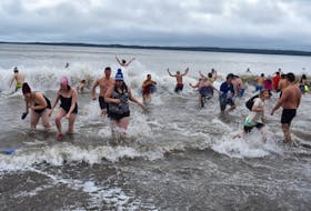 Some of the more than 75 participants of the eighth annual Port Morien Polar Dip take the icy plunge into the frosty waters of the Cape Breton fishing village’s sheltered harbour. Another 250 or so people stayed on shore watching and supporting those taking part in the popular New Year’s Day event. This year’s dip had an international flavour about a dozen young foreign students opted to participate in a New Year’s Day tradition that is popular across Canada.