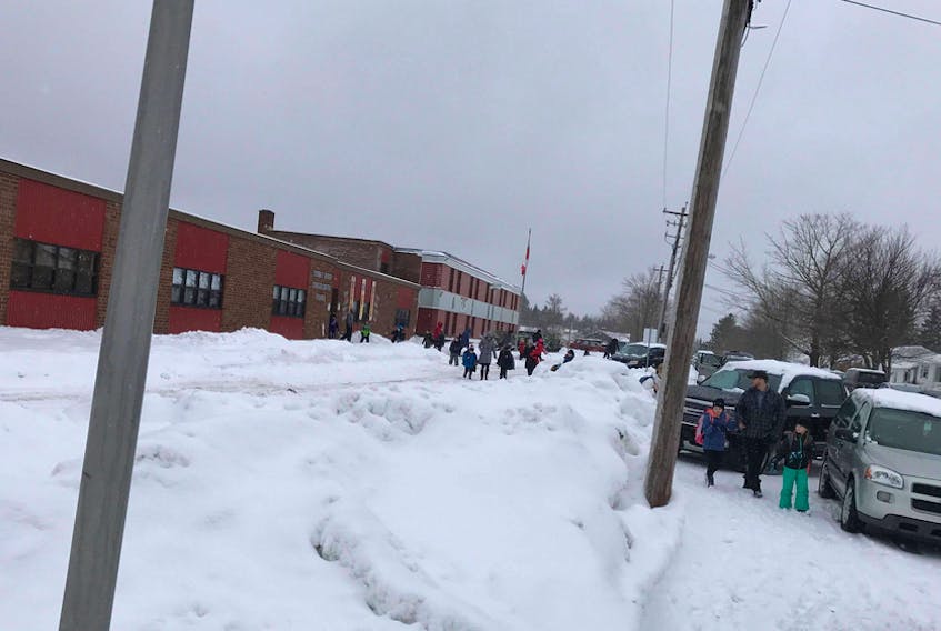 Parents pick up students from Sydney River Elementary School who don’t take the bus. Unplowed sidewalks and congestion on the street have some parents concerned for student safety.