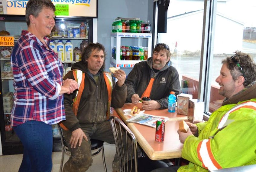 Donna Marie Young, from left, an employee at Kace Gas and Convenience at Dearns Corner on the Donkin-Morien Highway, chats with contractors working at the Donkin mine — Dave Pelrine of All Steel Builders in Port Hawkesbury, Marcel Gaigneur of Paul MacDonald’s Trucking in Birch Grove, and K.C. Pelrine, also of All Steel builders — as they have lunch on Wednesday. Owner Kevin Buchanan says the opening of Donkin mine has helped business.