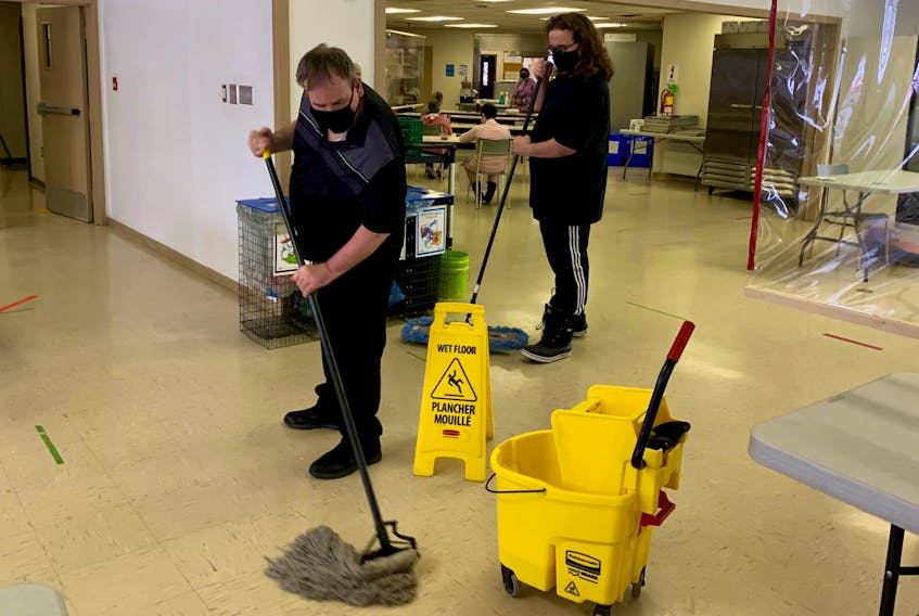 The Horizon Achievement Centre may be soon moving into a brand new building, but that’s not keeping maintenance workers from keeping things clean and tidy at centre’s present home on Upper Prince Street in Sydney. Above, the centre’s Troy Adams, left, mops the floor while fellow maintenance crew member Jamie Spears works the broom on Monday afternoon. The Horizon Achievement Centre, which offers vocational training and employment development services for adults with intellectual disabilities, is expected to move into its new $6.4-million complex this coming autumn.